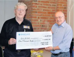  ??  ?? NLMGC Chairman, Colin Readwin, presents DLRAA fund-raiser, Tony Bradley, with a cheque for £1,000.