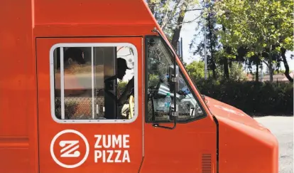  ?? Photos by Michael Macor / The Chronicle ?? Skylar Morris works behind the wheel of a van, heading up a crew for Zume, a Mountain View mobile pizza company.