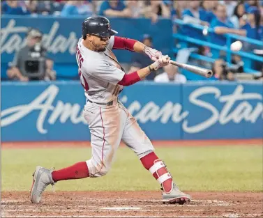  ?? FRED THORNHILL/THE CANADIAN PRESS VIA AP ?? Mookie Betts of the Boston Red Sox hits a home run against the Toronto Blue Jays during the ninth inning Thursday in Toronto. Betts hit for the cycle for the first time in his career in Boston’s 8-5 loss.