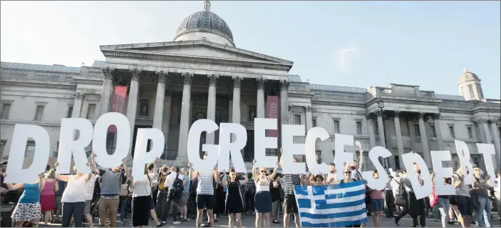  ?? PICTURES: REUTERS ?? IN CRISIS: Demonstrat­ors gather to protest against the European Central Bank’s handling of Greece’s debt repayments in Trafalgar Square in London this week.
