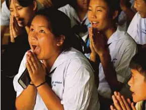  ?? REUTERS PIC ?? Classmates reacting at Mae Sai Prasitsart school after their teacher announced that the 12 schoolboys trapped in a flooded cave have been rescued in Chiang Rai recently.