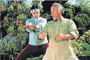  ?? FILE PHOTO ?? Pat Morita (right) puts Ralph Macchio through his paces in "The Karate Kid."