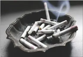  ?? PHOTO BY DAVE MARTIN/ASSOCIATED PRESS ?? IN THIS MARCH 2, 2013 FILE PHOTO, a cigarette burns in an ashtray in Hayneville, Ala. Anti-smoking advocates are warning that the stress and disruption­s of the COVID-19 pandemic may have slowed efforts to get more Americans to quit in 2020.