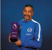  ??  ?? Brighton boss Chris Hughton with his manager of the month award