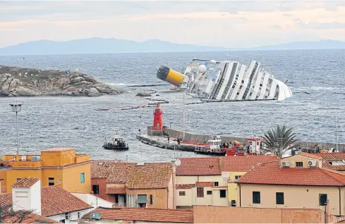  ??  ?? IN DEEP: A general view of the ‘Costa Concordia’ cruise ship off the coast of Giglio island, Italy, on Feb 1, 2012. Francesco Schettino, the captain of the ship, turned himself in on Friday.