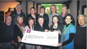  ?? (Pic: The Avondhu Archives) ?? Representa­tives from Liam’s Lifts in 2017 - Triona O’Flynn, Yvonne Leahy and Nelius O’Flynn – accepting funds from Anne Dolan (front centre) and friends in Cheers Bar, Fermoy – one of the many donations the service has received through the years. Pictured were, front l-r: Gerry Feerick, Maura O’Leary, Helen Griffin, Anne Dolan, Yvonne Leahy (secretary Liam’s Lifts), Triona O’Flynn (chairperso­n) and Nelius O’Flynn (treasurer); Back l-r: Gus Kelleher (driver), Rachel O’Leary, Mary Corcoran, Pauline Joyce and Ann Feerick.