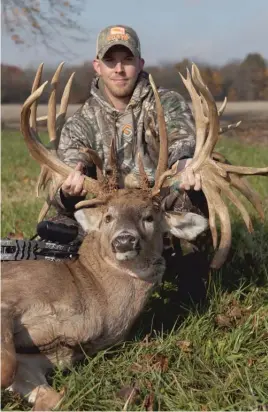  ??  ?? Luke Brewster with “Mufasa,’’ taken by arrow Nov. 2 in Edgar County. The buck was officially measured at a net of 320 5/8 inches and is a pending world record.