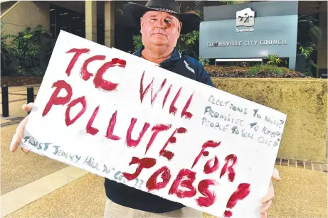  ?? Picture: ALIX SWEENEY ?? DETERMINED: Woodstock Action Group president Chris Eastaughff­e protests against the Lansdown Industrial Precinct outside the Townsville City Council building.