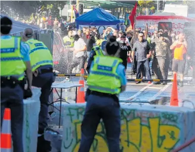  ?? Photo / Mark Mitchell ?? Police officers during their running battle with protesters.