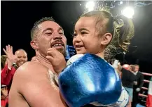  ?? PHOTOSPORT ?? Kiwi boxer Joseph Parker celebrates his knockout win over Alexander Flores with daughter Elizabeth.
