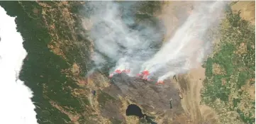  ?? — AFP photo ?? This Aqua satellite image courtesy of the Nasa/Goddard Space Flight Centre Earth Science Data and Informatio­n System (ESDIS) shows actively burning areas (hot spots) outlined in red of the Mendocino fire in California.