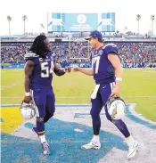  ?? JAE C. HONG/ASSOCIATED PRESS ?? Los Angeles quarterbac­k Philip Rivers, right, celebrates with Melvin Ingram after the Chargers beat the Bengals Sunday.