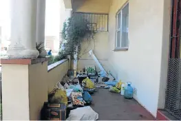  ?? Pictures: MALIBONGWE DAYIMANI ?? SQUATTING: This vagrant, right, is apparently terrorisin­g families at a block of flats in the Quigney. Below, Zameka Cuntu is scared of entering her own home because of the ‘dangerous’ vagrant occupying her veranda.