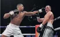  ?? PHOTO: REUTERS ?? From the left . . . Anthony Joshua and Joseph Parker in action in the World Heavyweigh­t Title Unificatio­n Fight at Principali­ty Stadium in Cardiff yesterday.