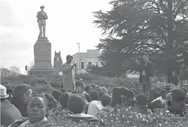  ?? James Peppler/Alabama Department of Archives and History via AP ?? ■ Frank Toland, a professor at what is now called Tuskegee University, speaks to protesters gathered around the Confederat­e monument in 1966 in Tuskegee, Ala. Demonstrat­ors protesting the shooting death of a black man later attempted to pull down the monument, which remains in the mostly black city.