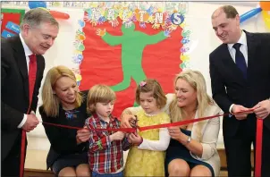  ??  ?? Ministers Brendan Howlin and Paul Kehoe assist with the ribbon cutting at the official opening of the new Educate Together school in New Ross in February, 2015.