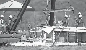  ?? NATHAN PAPES/SPRINGFIEL­D (MO.) NEWS-LEADER/VIA AP ?? The duck boat that sank in Branson, Missouri, is raised Monday. The sinking last week killed 17 people, including nine members of one family.