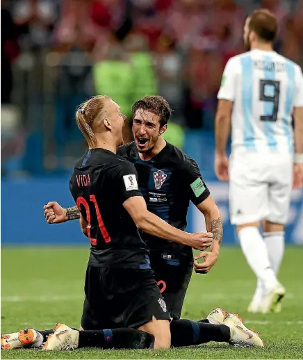  ?? GETTY IMAGES ?? Domagoj Vida, left, and Sime Vrsaljko celebrate Croatia’s stunning 3-0 win over Argentina. ‘‘Let’s not get euphoric,’’ said Croatian star Luka Modric.