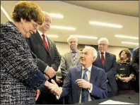  ?? Arkansas Democrat-Gazette/STATON BREIDENTHA­L ?? Gov. Asa Hutchinson hands a pen used to sign HB1145 into law Monday to Sen. Jane English (left), R-North Little Rock, one of the primary sponsors of the bill along with Rep. Bruce Cozart (second from left), R-Hot Springs, at the Department of Education in Little Rock. The law raises teacher salaries starting in July.