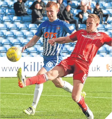  ??  ?? ■ Aberdeen’s Adam Rooney tries to control the ball as Killie’s Scott Boyd waits to challenge.