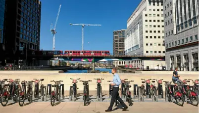  ?? Picture: REUTERS ?? A man walks through London's Canary Wharf Financial District. Among the hardest hit sectors post-Brexit has been UK commercial property.