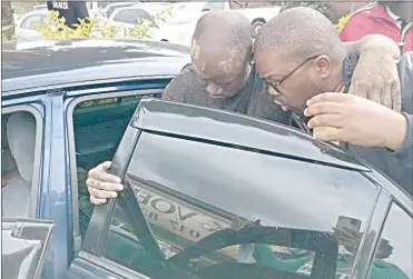  ?? (Pics sourced from SNUS Facebok page) ?? The injured SNUS President, Colani Maseko (L), being assisted by PUDEMO Secretray General Wandile Dludlu to get into the car which rushed him to hospital after he was brutalised by soldiers.