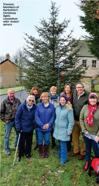  ??  ?? Treeson: Members of Harbottle’s Christmas lights committee with ‘stolen’ spruce