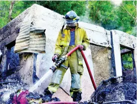  ?? KENYON HEMANS PHOTOS ?? Fire ravaged this two-bedroom house in Burnside Valley, Red Hills, St Andrew, yesterday.