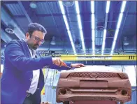  ??  ?? Tata Motors head of design Pratap Bose with Tiago clay model