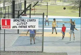  ?? Adam Robison Associated Press ?? RESIDENTS ignore the closure of basketball courts at Gumtree Park in Tupelo, Miss. Gov. Tate Reeves has refused to shut down businesses in the state.