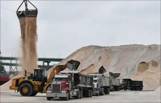  ?? CHRIS CHRISTO — BOSTON HERALD ?? Salt from Chile is unloaded from a ship at Eastern Salt Company in Chelsea on Sunday, then loaded onto trucks for this week’s predicted storm.