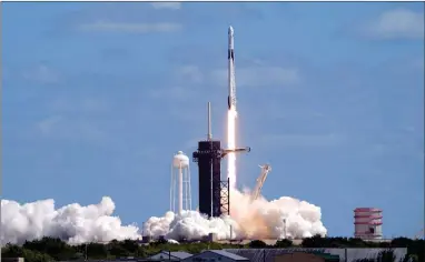  ?? AP PHOTO BY JOHN RAOUX ?? A Spacex Falcon 9 rocket and the Dragon capsule, with a multinatio­nal crew of four astronauts, lifts off from Launch Complex 39-A Wednesday, Oct. 5, 2022, at the Kennedy Space Center in Cape Canaveral, Fla., beginning a five-month mission to the Internatio­nal Space Station.