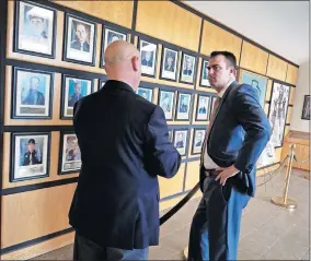  ?? [BEN FELDER/THE OKLAHOMAN] ?? Gov. Kevin Stitt, right, visits with Department of Public Safety Commission­er Rusty Rhoades on Thursday at the Highway Patrol academy in Oklahoma City.