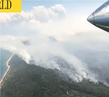  ?? QLD FIRE AND EMERGENCY VIA AP ?? Fires burn north of Bundaberg, Australia, as firefighte­rs battle flames in heat of up to 40 C and winds of 40 km/h.