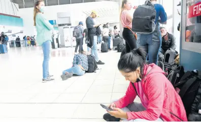  ?? RUDOLPH BROWN/MULTIMEDIA PHOTO EDITOR ?? Stranded travellers at the Norman Manley Internatio­nal Airport in Kingston as a result of industrial action by air traffic controller­s on Thursday, May 12.