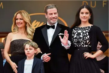  ?? — AFP ?? Travolta, with his wife Preston (left) and their children Ella Bleu (right) and Benjamin in Cannes last week.