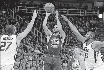  ?? [RICK BOWMER/THE ASSOCIATED PRESS] ?? Golden State Warriors guard Stephen Curry shoots as the Utah Jazz’s Rudy Gobert, left, and Boris Diaw defend in the first half during Game 4 of their second-round playoff series Monday in Salt Lake City. Rockets’ Nene out for season: Raptors’ Lowry...