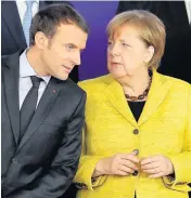  ??  ?? > Emmanuel Macron and Angela Merkel