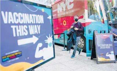  ?? MARY ALTAFFER/AP 2021 ?? A man exits from a mobile vaccine clinic in midtown Manhattan.