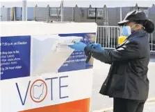  ?? TONYDEJAK/APFILEPHOT­O ?? Marcia McCoydrops her ballot into a box outside the Cuyahoga County Board of Elections in Cleveland, Ohio, onApril 28.Voters in Lehigh County will have the opportunit­y to cast their ballots in designated drop boxes throughout the county before the Nov. 3 election.