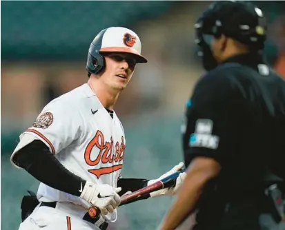  ?? JULIO CORTEZ/AP ?? Orioles catcher Adley Rutschman, left, looks at home plate umpire Malachi Moore after he called him out on strikes Wednesday in a 4-1 loss to the Toronto Blue Jays in Baltimore.