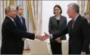  ?? AP PHOTO/ALEXANDER ZEMLIANICH­ENKO ?? Russian President Vladimir Putin, left, shakes hands with U.S. National security adviser John Bolton during their meeting in the Kremlin in Moscow, Russia on Tuesday.