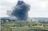  ?? — AFP ?? Smoke billows after an Israeli strike on the southern Lebanese border village of Tayr Harfa.