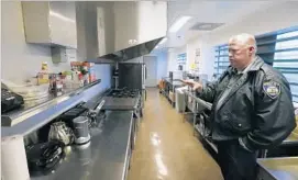  ??  ?? RANDY NEITZKE, Beverly Hills Police jail supervisor, shows off the kitchen where pay-to-stay inmates can cook the food they’ve brought in.