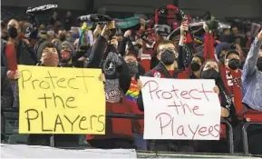  ?? STEVE DIPAOLA AP ?? Portland Thorns fans hold signs during the first half of the team’s NWSL match against the Houston Dash in Portland, Ore., in response to reports of coach misconduct.