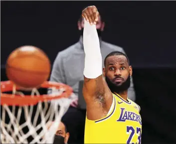  ?? AP PHOTO/MARK J TERRILL ?? Los Angeles Lakers forward LeBron James shoots during the first half of an NBA basketball game against the Oklahoma City Thunder Monday in Los Angeles.