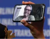  ??  ?? Iranian actress Baran Rasoulof holds a phone displaying Iranian director Mohammad Rasoulof who was awarded the “Golden Bear for Best Film” attends a press conference after the awarding ceremony of the 70th Berlinale film festival in Berlin on February 29, 2020. — AFP photos