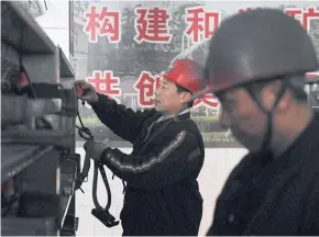  ??  ?? HASTY MOVES: Workers putting away equipment after coming out of the Datai coal mine in Mentougou, west of Beijing. Moves to cut carbon emissions and switch to renewables harm the poor.