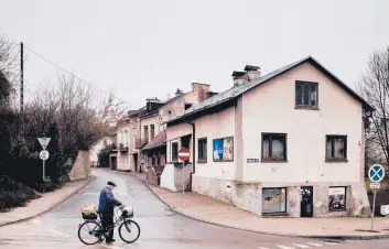  ?? KASIA STREK/THE NEW YORK TIMES ?? A cyclist March 29 in Krasnik, Poland. In 2019, the town voted to be “free of LGBT” to satisfy conservati­ve voters. The mayor now regrets the move, which has led to censure from other countries and put funding at risk.