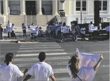  ?? PHOTO GARY REDFERN ?? Protesters gather in front of the Imperial County Courthouse and Administra­tion Center on Friday afternoon to protest because the District Attorney’s Office has not yet filed charges in the Oct. 20 homicide of Rose Jamie Campos.